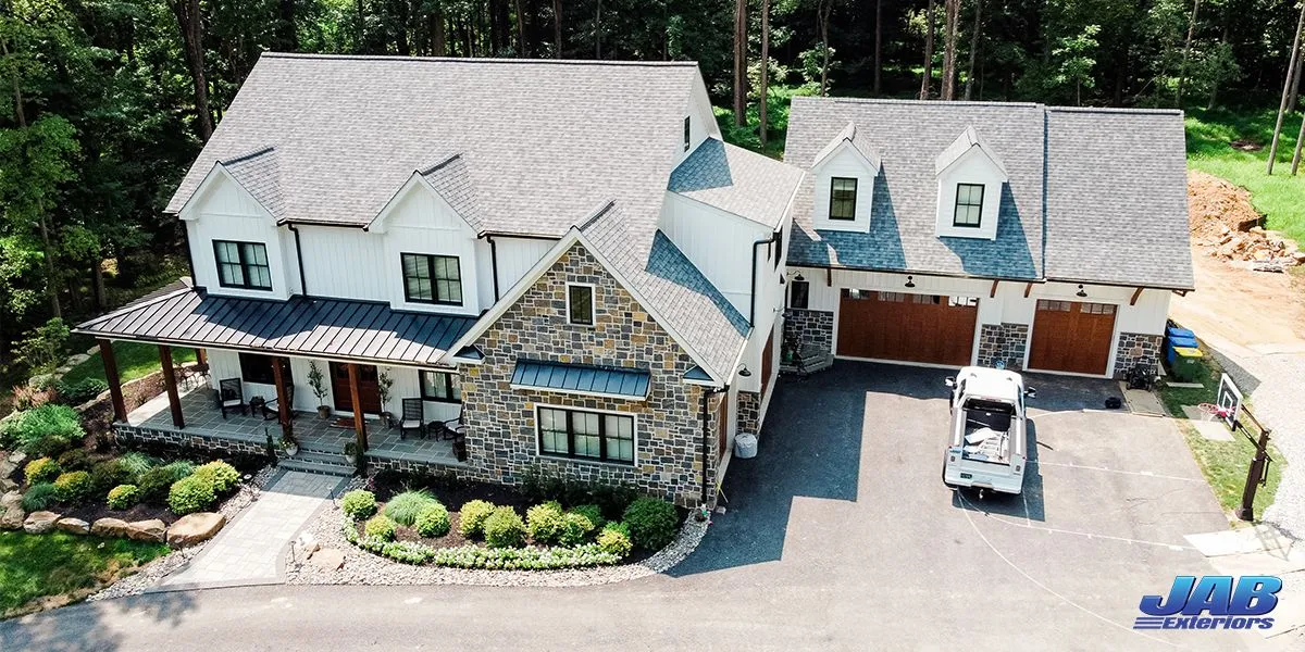 Aerial view of a completed JAB Exteriors roofing and siding project