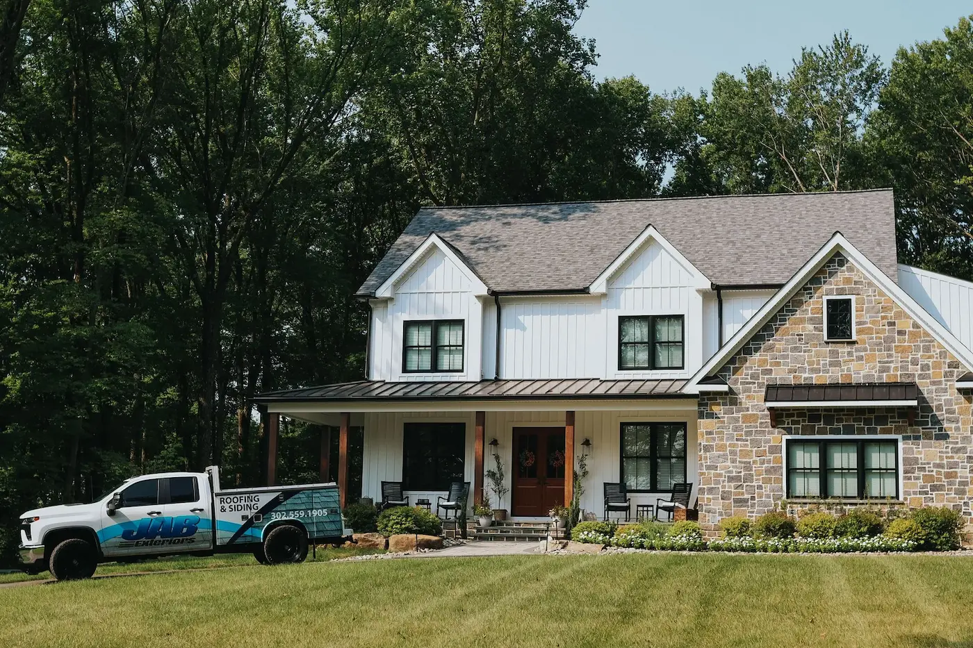 JAB Exteriors truck parked in front of a completed home exterior project